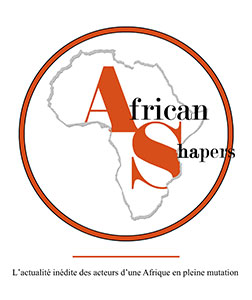 African Shapers logo is a gray outline of the continent of Africa which is used as a clipping path for the first letter of each word ('A' and 'S') which are also much larger than the other letters, colored burnt sienna and nearly filling the continent of Africa. The 'A' is in the top left and the 'S' in the bottom right. There is a slight overlap in line height.  The font is a thin serif font. The rest of the smaller black letters are allowed to overflow out of the clipping path and in fact 'Shapers' is allowed to overflow outside of the burnt sienna thick round border that is encircling the continent. The border itself is outlined on both sides in thin black. The word 'African' is a larger font size than 'Shapers' but the 'A' and 'S' appear to be same height. The word 'Shapers' is below 'African' and offset to the right.